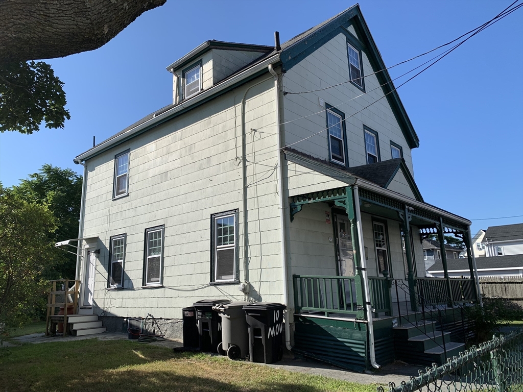 a view of a house with a wooden deck