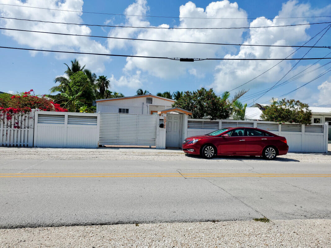 a view of parking space and a car parked on the road