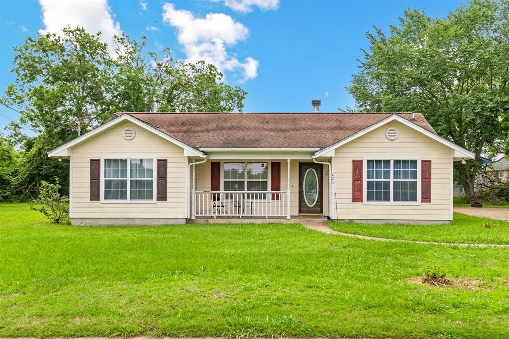 a front view of a house with a yard and porch