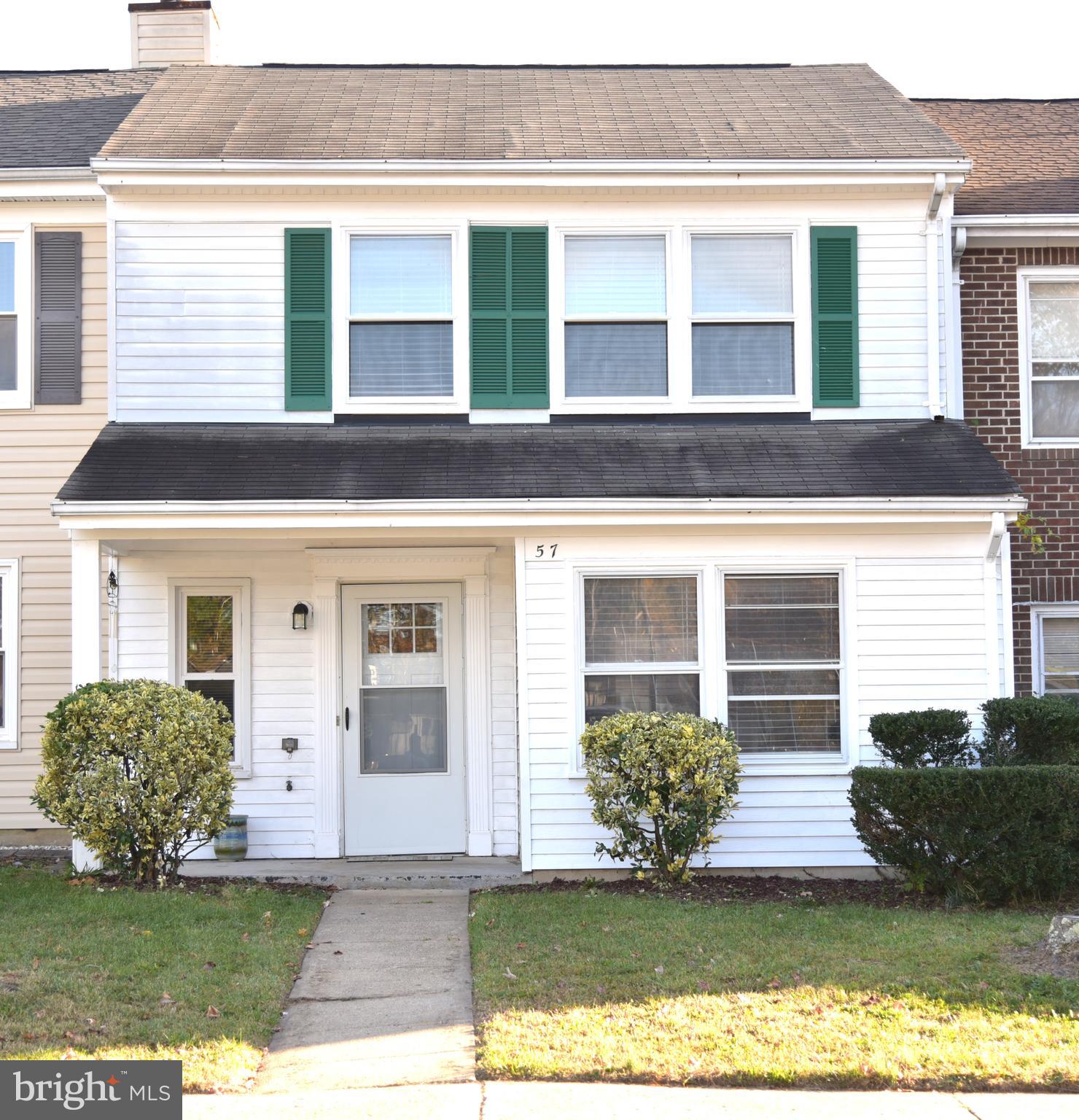 a view of a house with a small yard and a large window