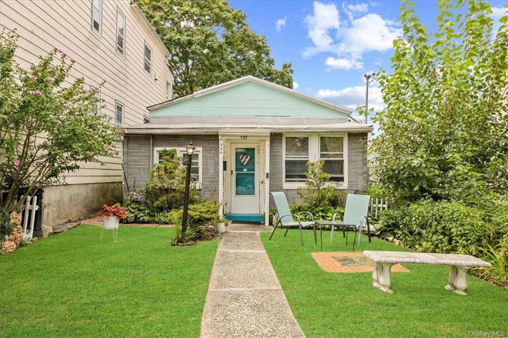 Bungalow-style house featuring a front lawn