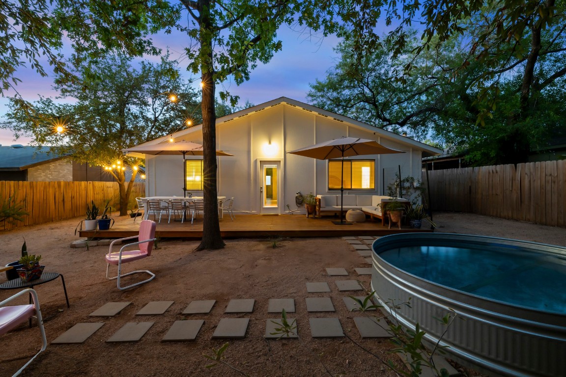 a view of swimming pool with chairs and fire pit