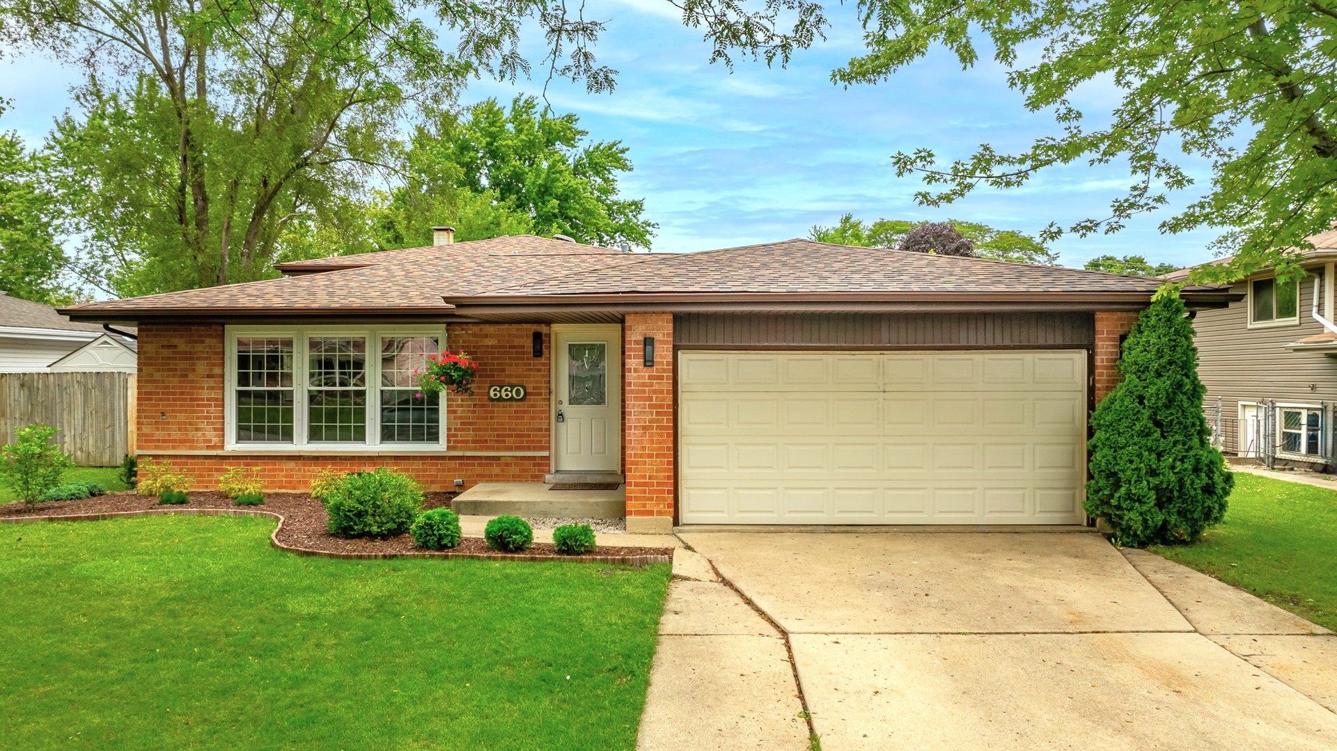 a front view of a house with a garden