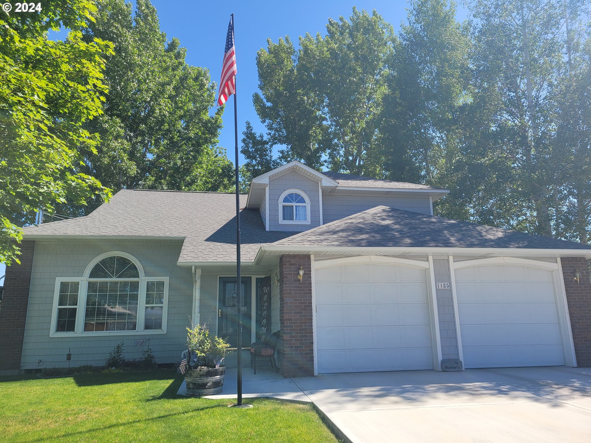 a front view of a house with garden