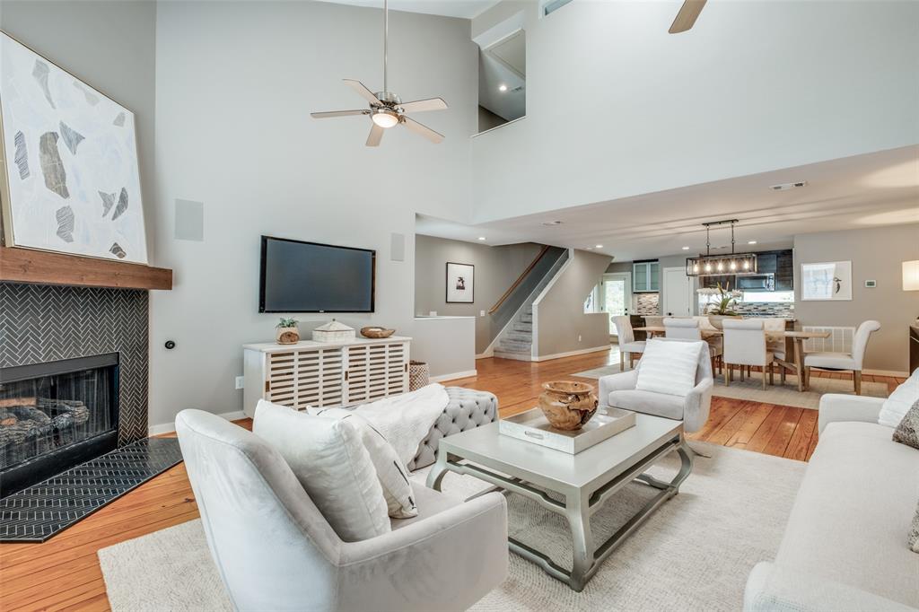 a living room with furniture kitchen view and a fireplace