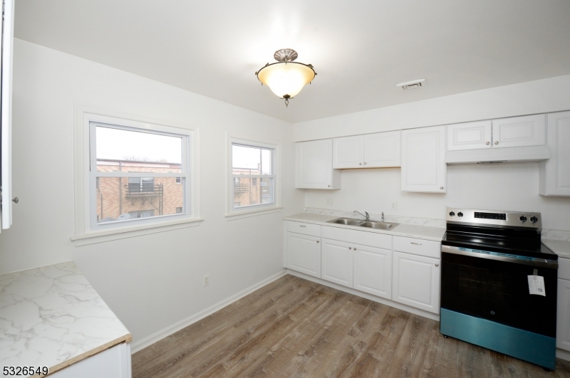 a kitchen with sink and cabinets