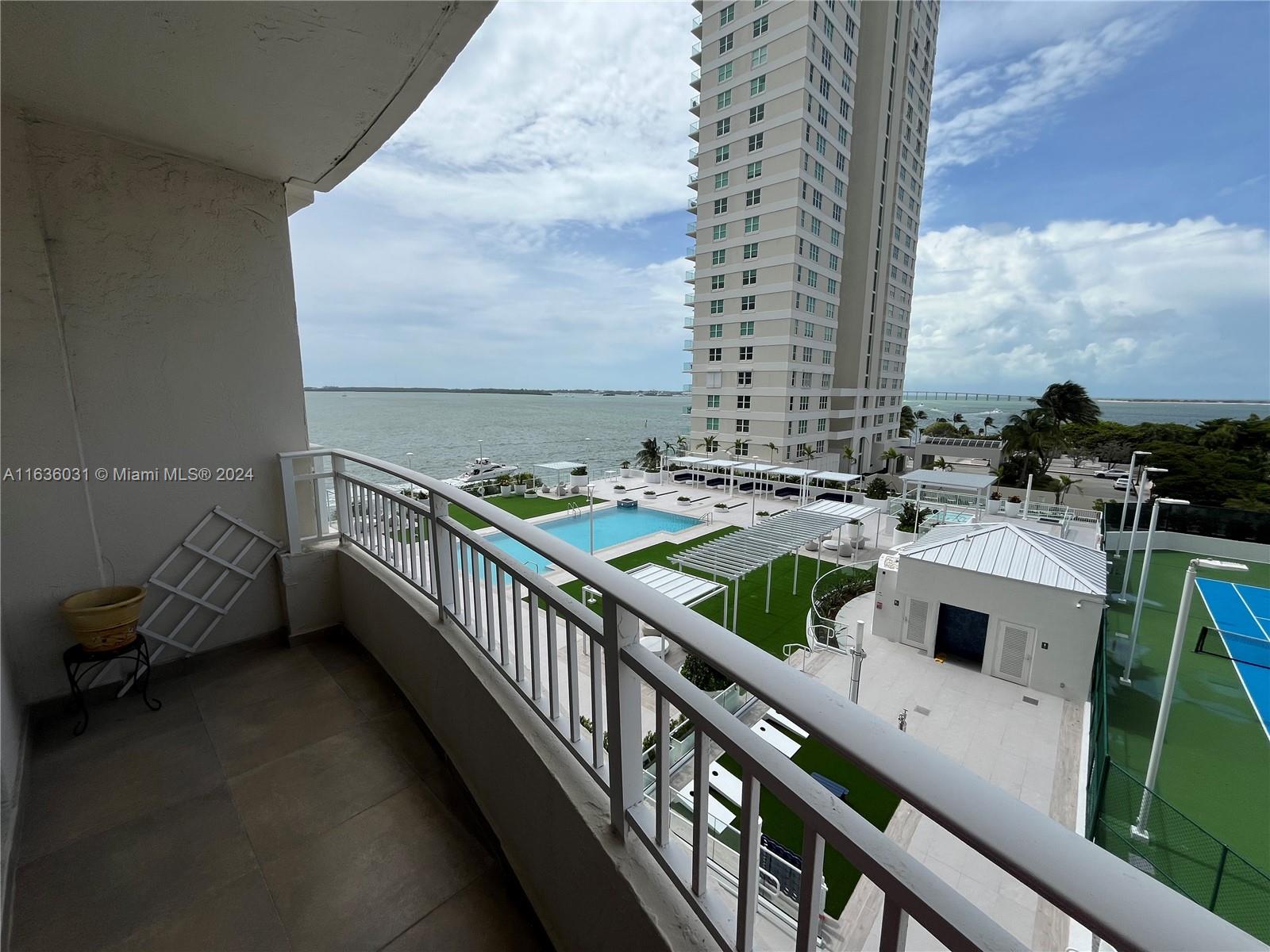 a balcony with furniture and a table