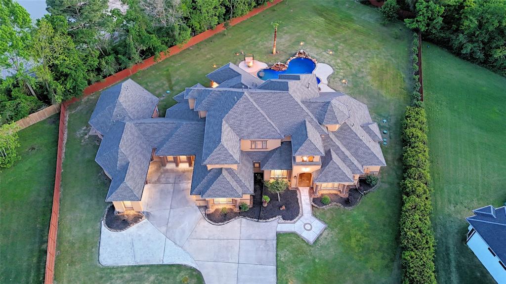 an aerial view of a house with garden space and street view