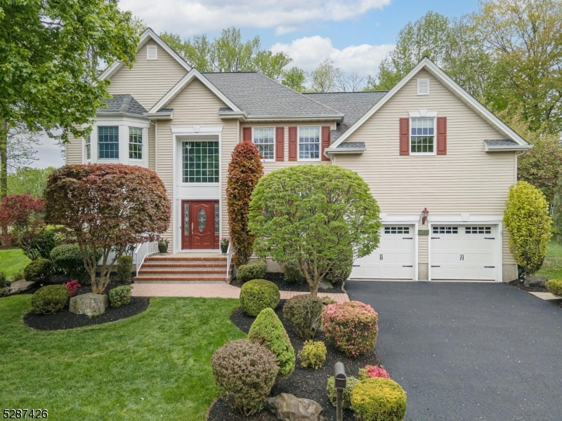 a view of a house with backyard and a garden