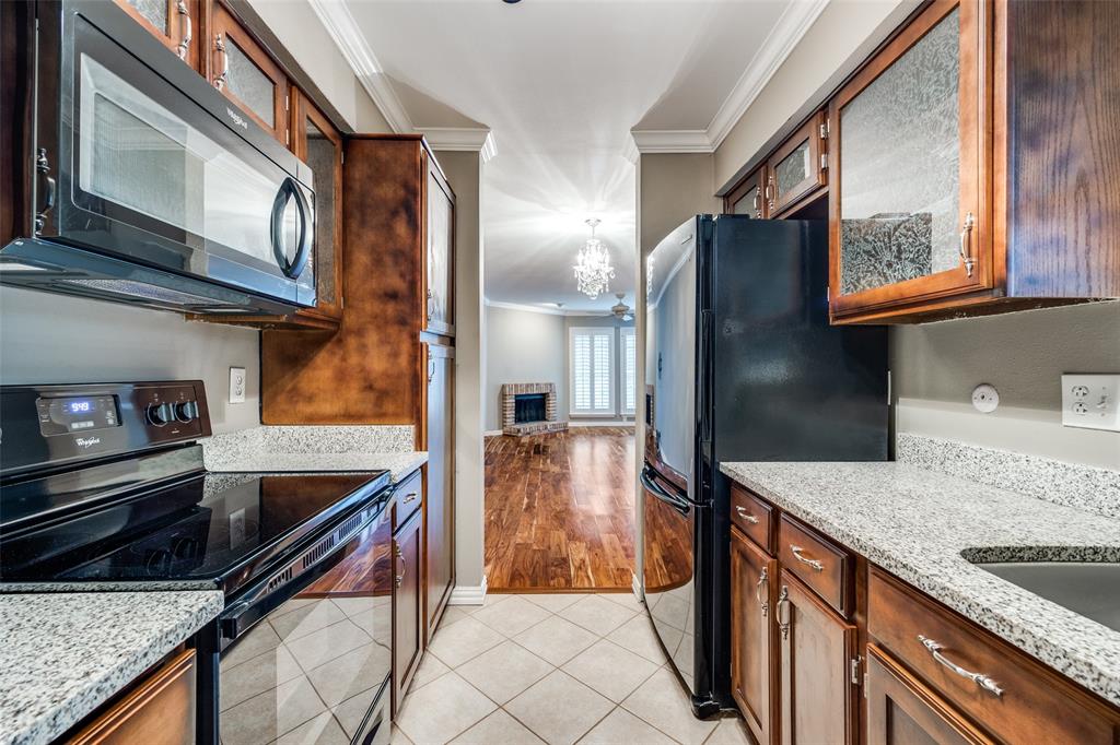 a kitchen with stainless steel appliances granite countertop a refrigerator and a sink