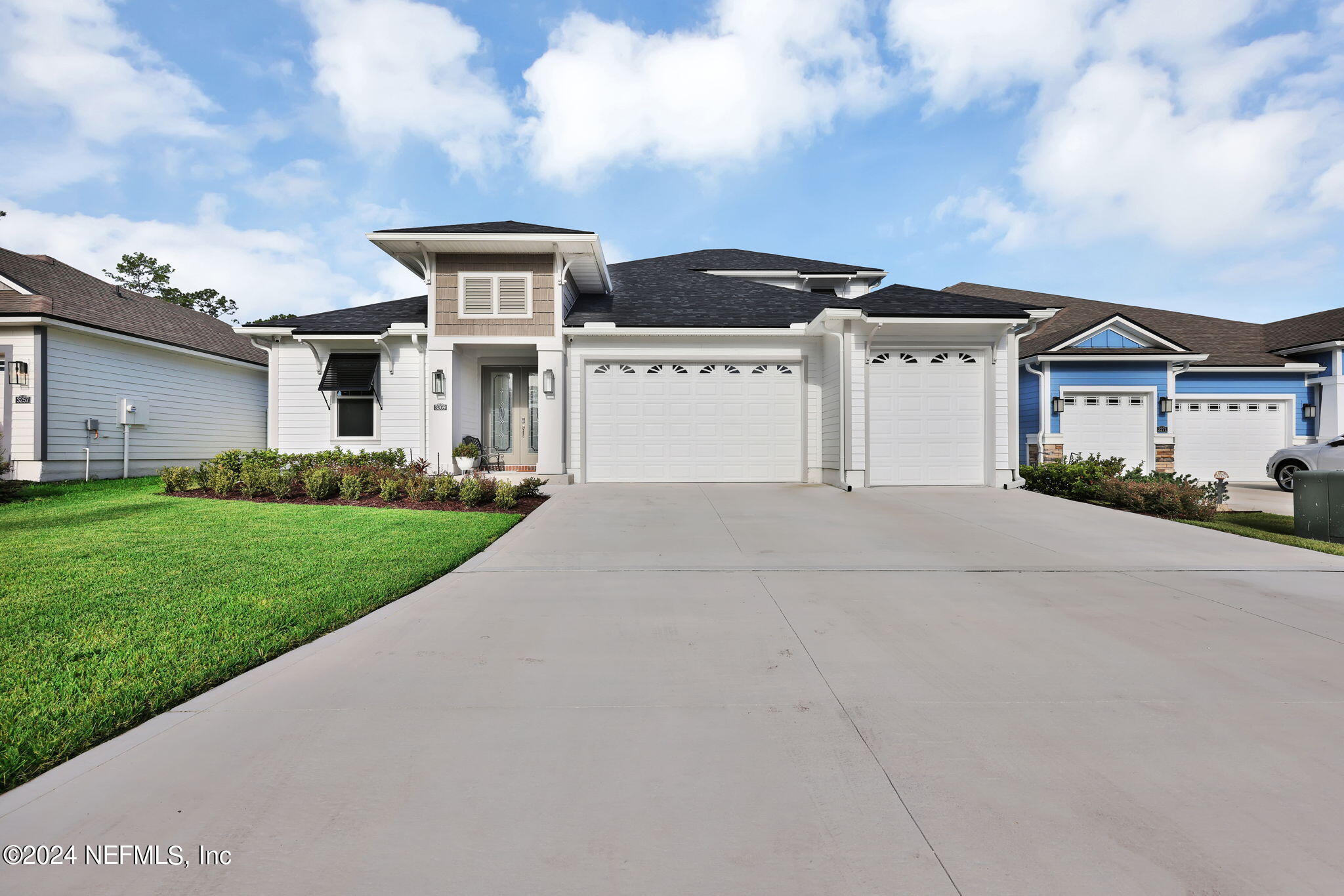 a front view of a house with a garden and yard