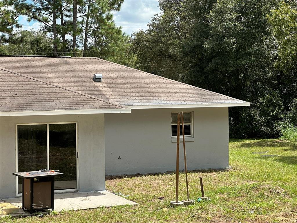 a backyard of a house with table and chairs