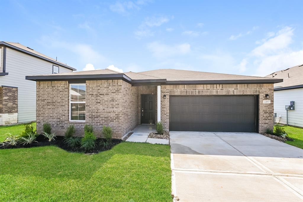 a front view of house with yard and garage