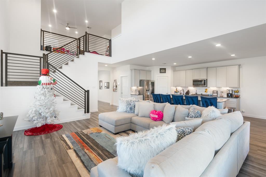 a living room with furniture and kitchen view