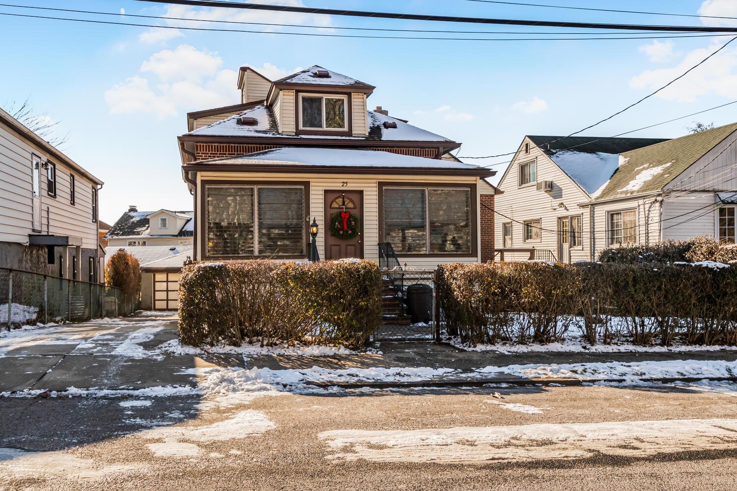 Picture Perfect 2 Family Brick Home with a long Driveway and 2 Car Garage