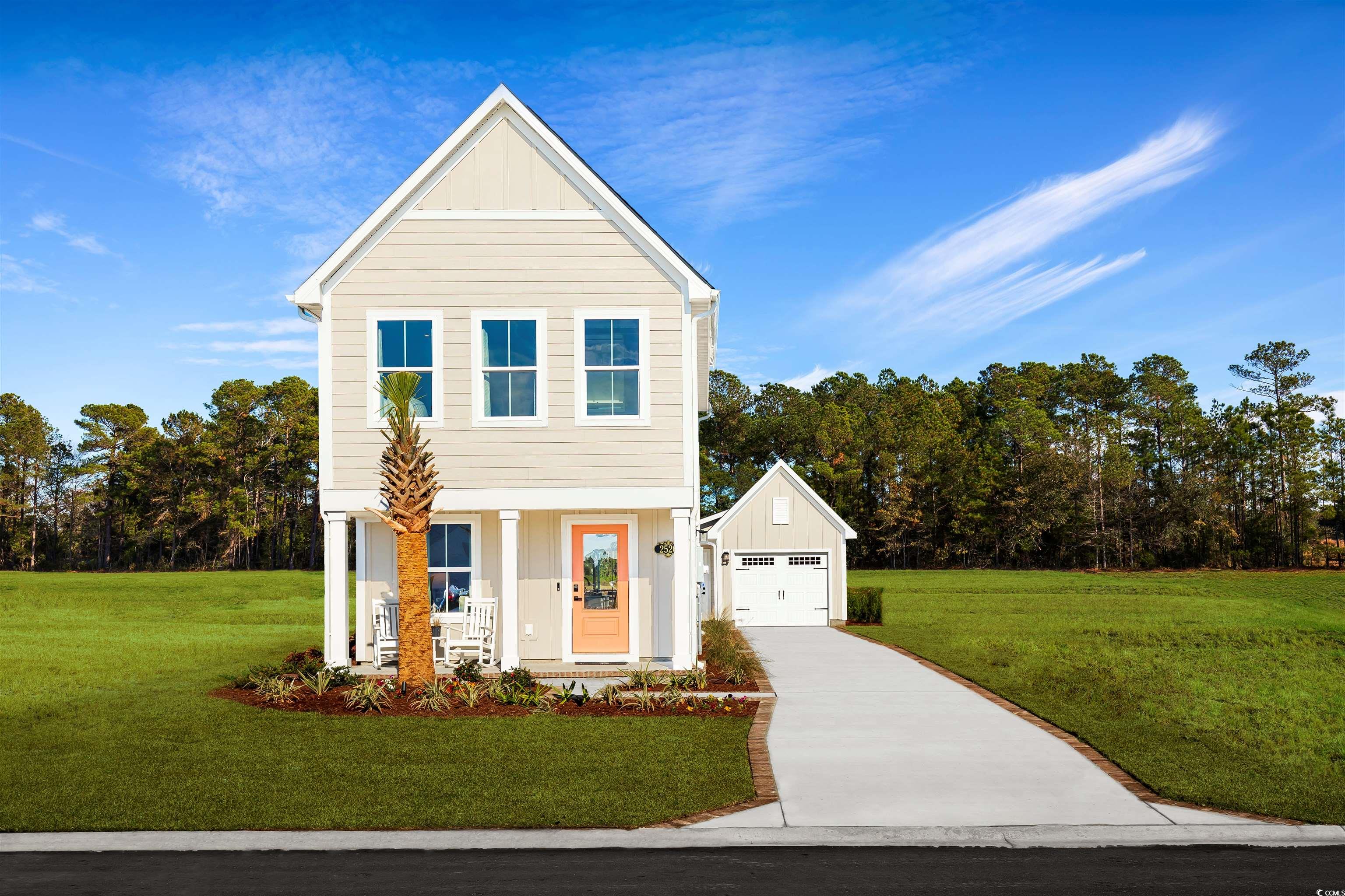 View of front facade with a front lawn, a garage,