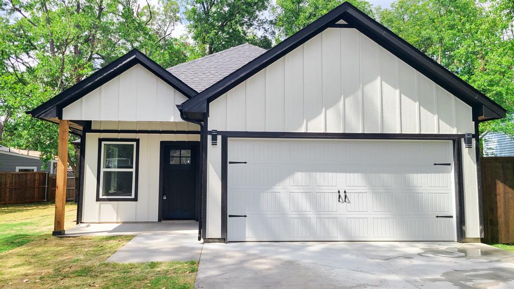 a view of a house with a yard and garage