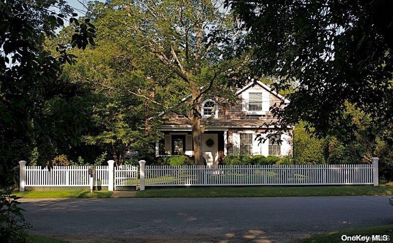 a front view of a house with a garden and plants