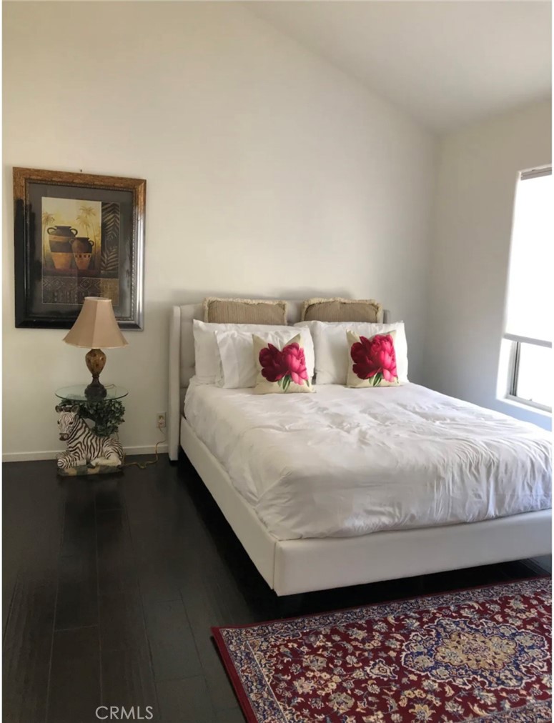 a bedroom with a bed and dresser