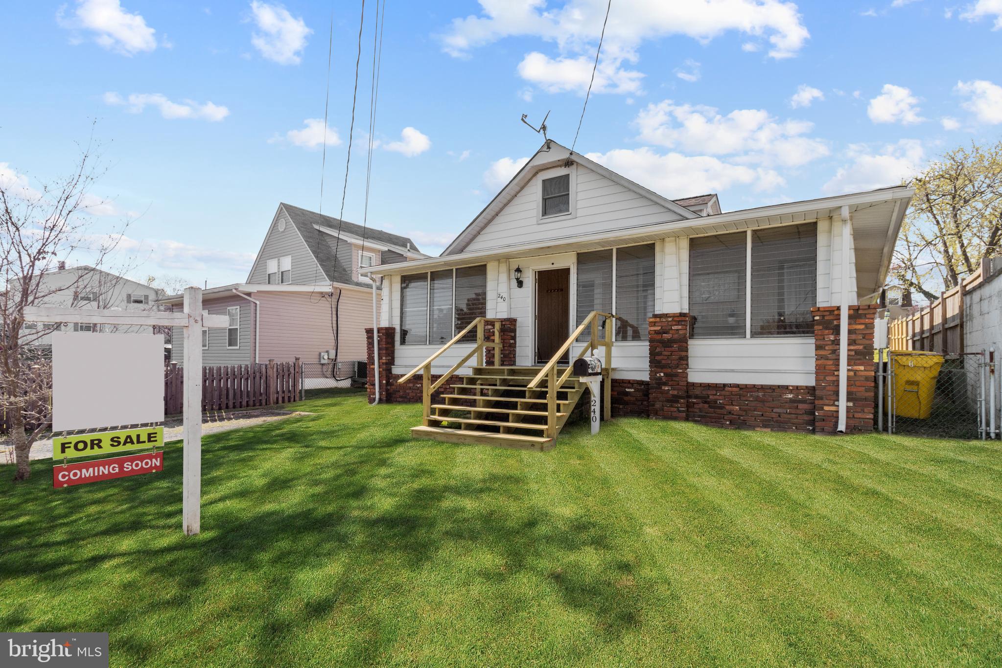 a view of a house with a yard and sitting area