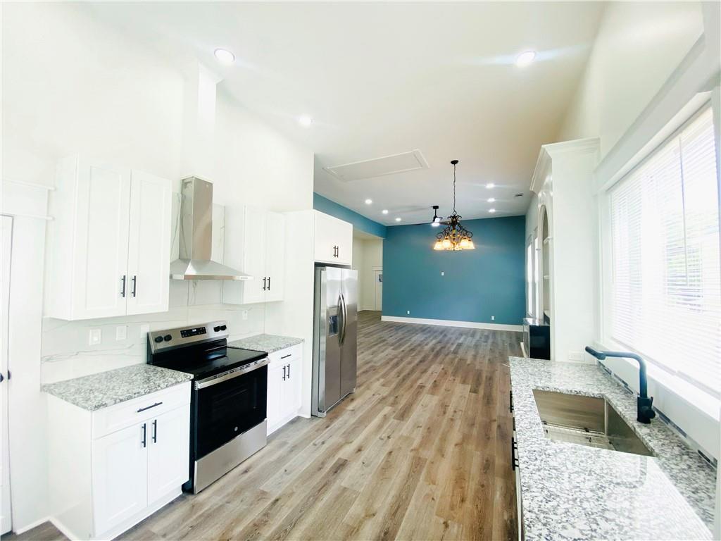 a kitchen with granite countertop a stove and a refrigerator