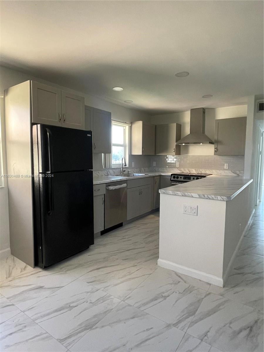 a kitchen with a refrigerator and a sink