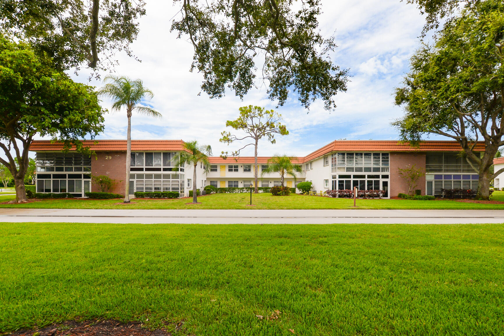 a front view of a building with a garden