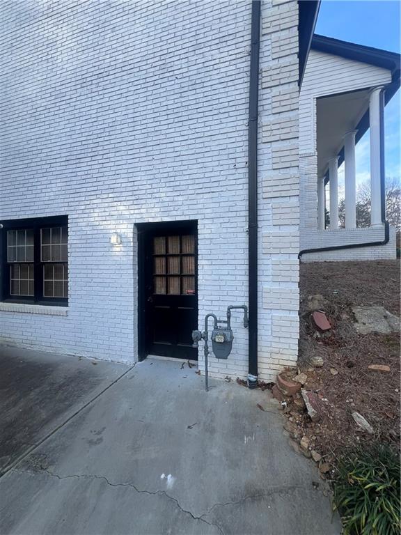 a view of a brick house with a large window