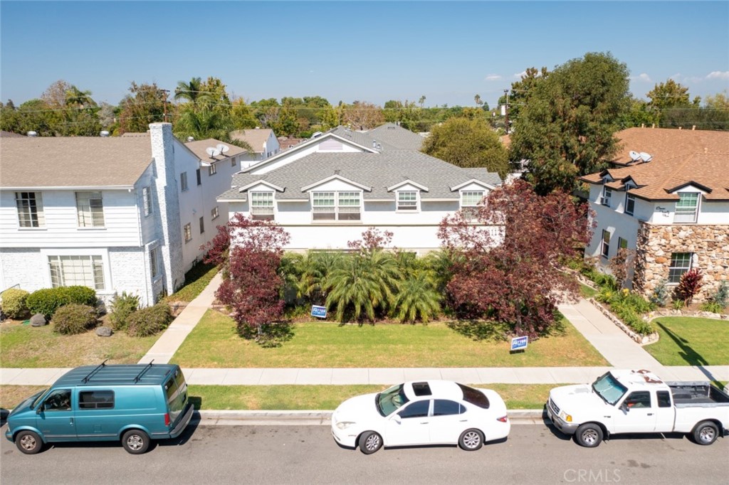 an aerial view of a house with a garden and parking space