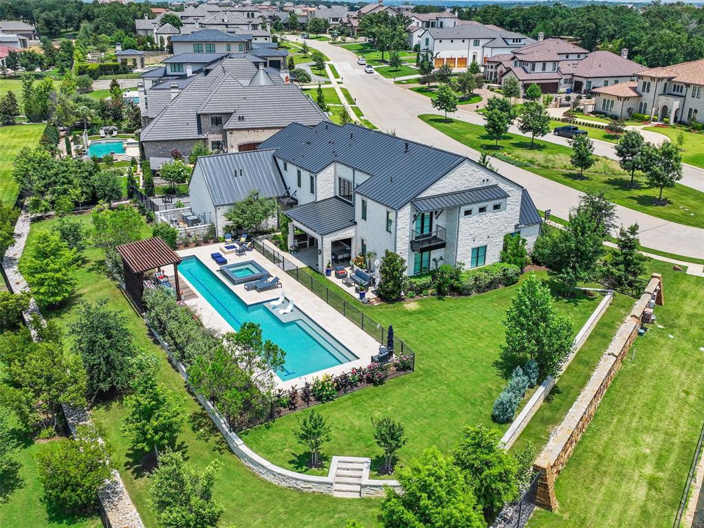 an aerial view of residential houses with outdoor space and street view