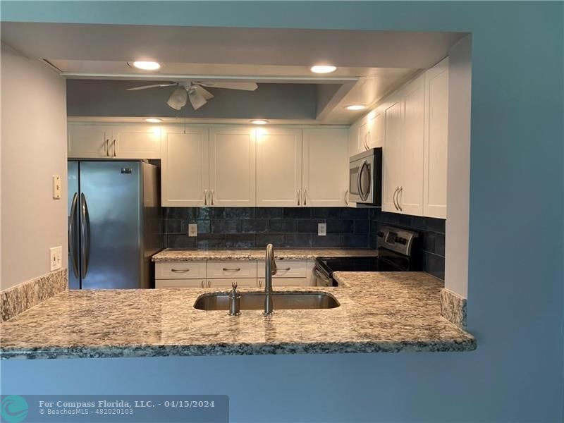 a bathroom with a faucet sink and a mirror