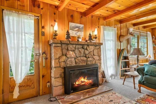 a living room with a fireplace furniture and a fireplace