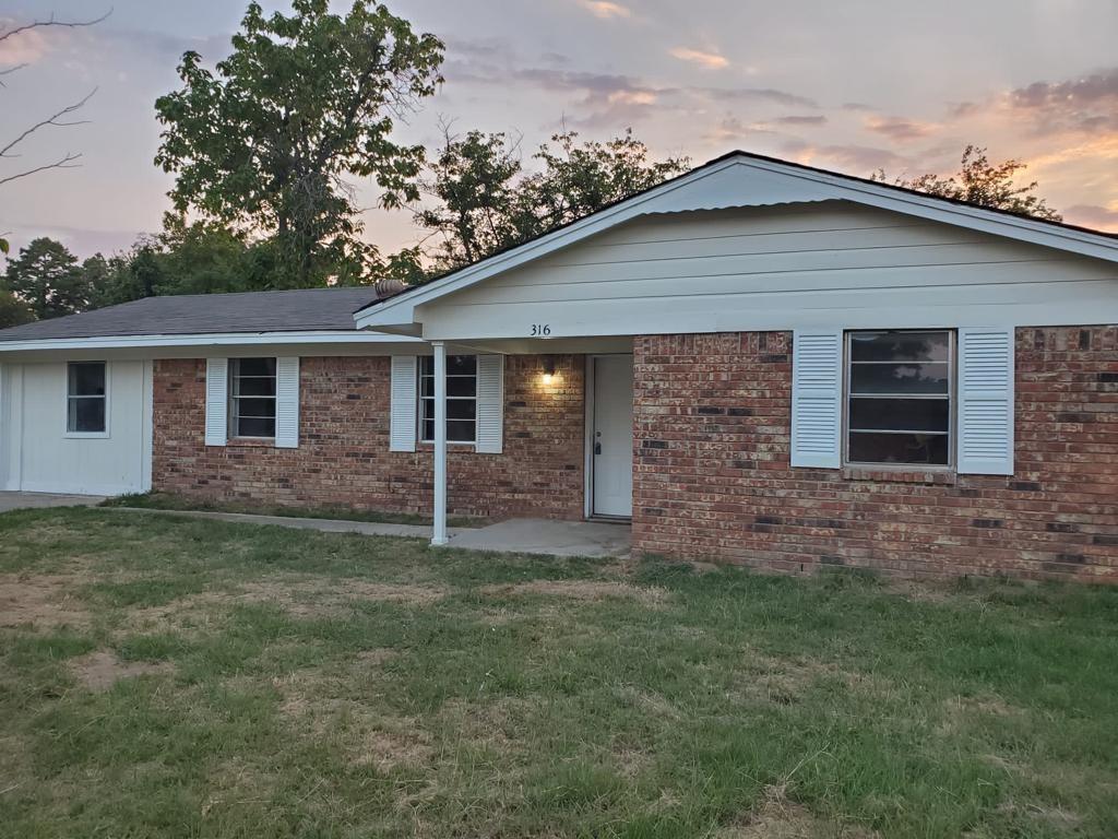 a brick house with a yard