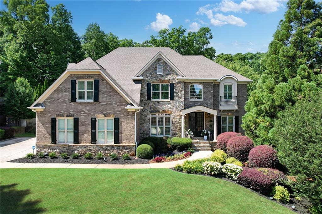 a front view of a house with a garden