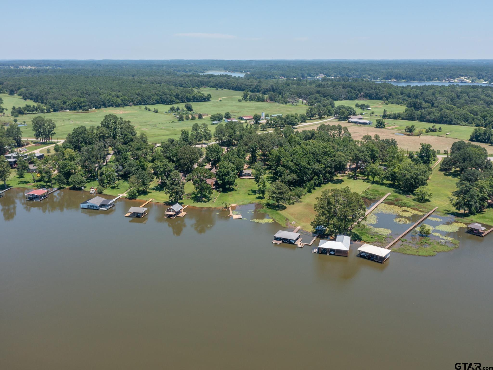 an aerial view of a houses with a lake view