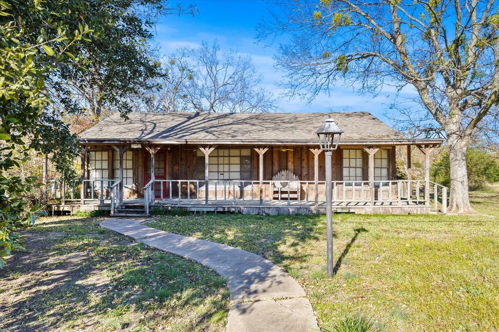 a front view of a house with a yard table and chairs