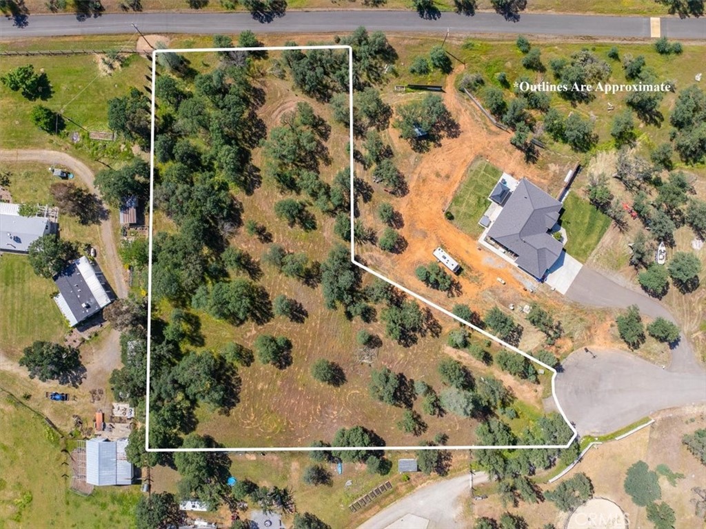 an aerial view of a residential houses with yard