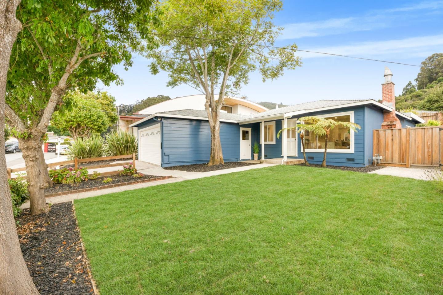 a front view of house with yard and green space