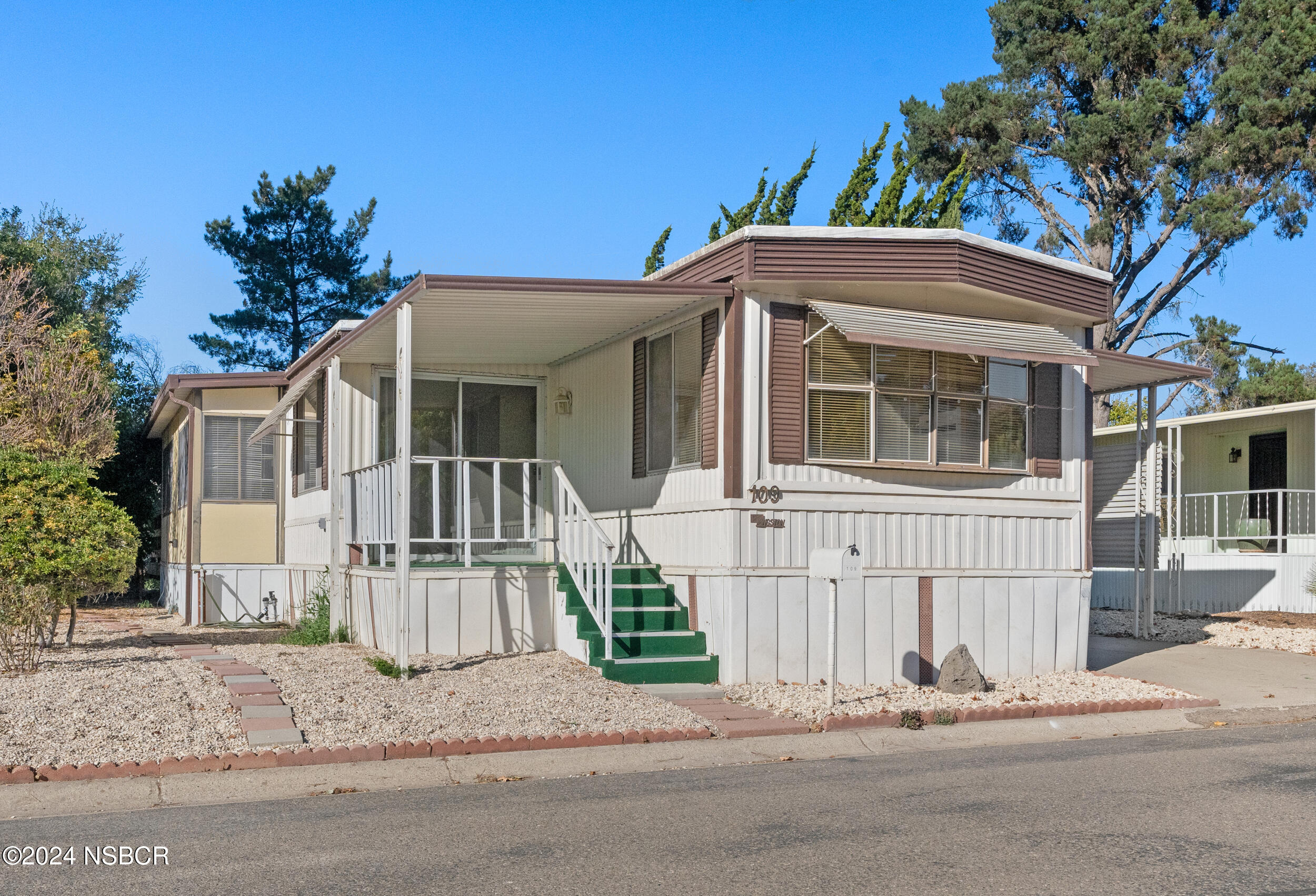 a front view of a house with a garden