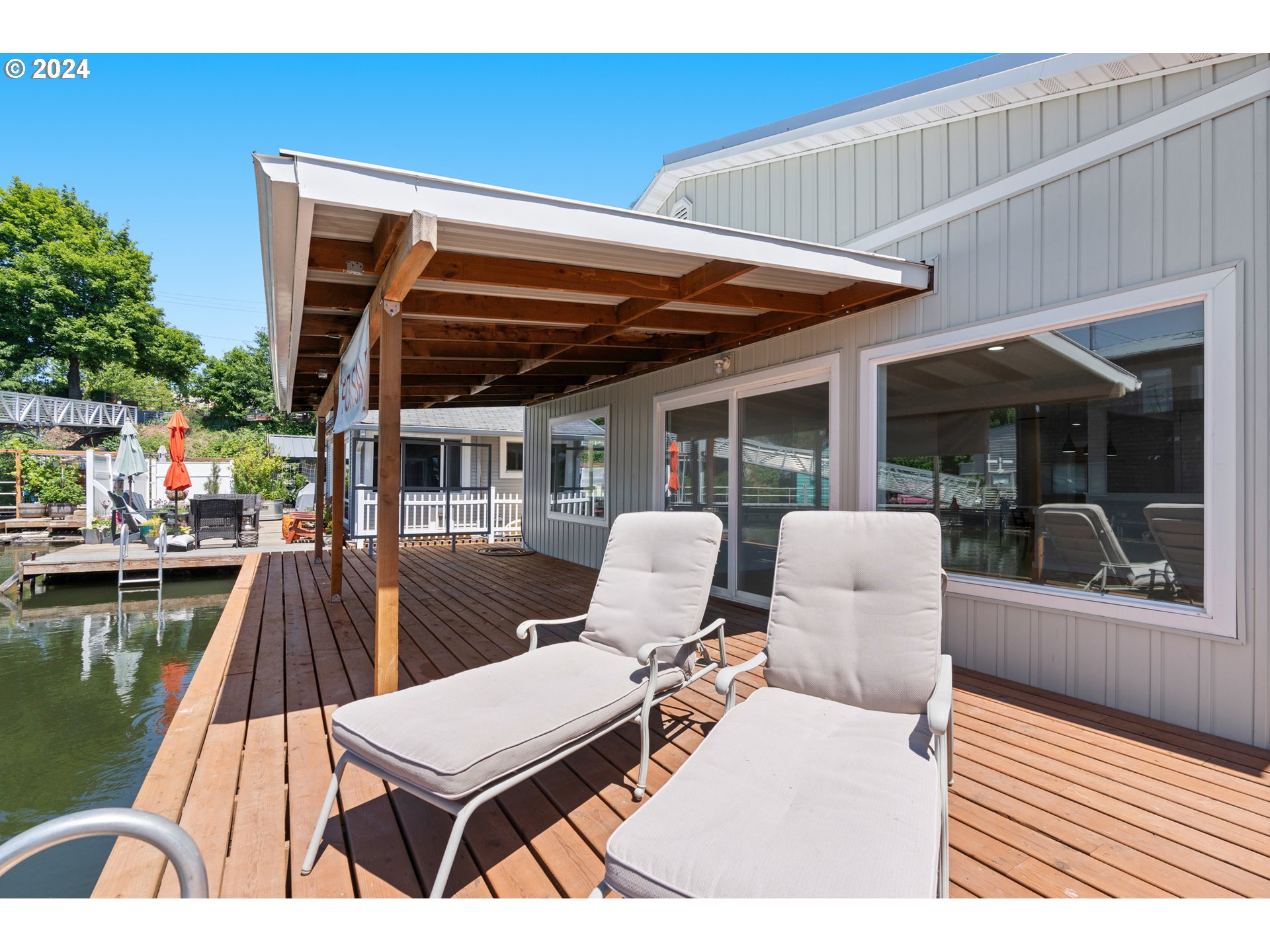 a view of a patio with tables and chairs with wooden floor and fence