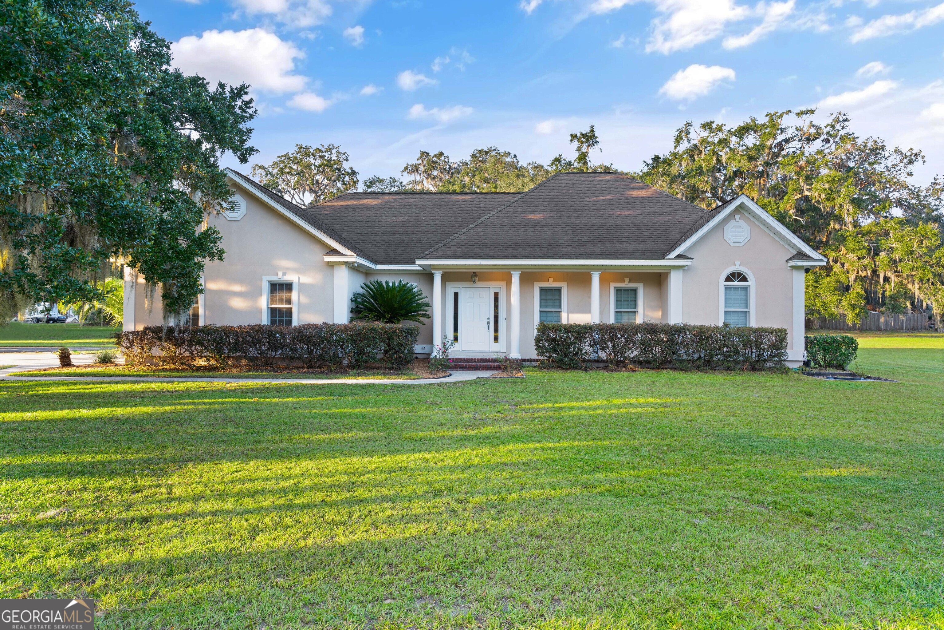 a front view of a house with a garden