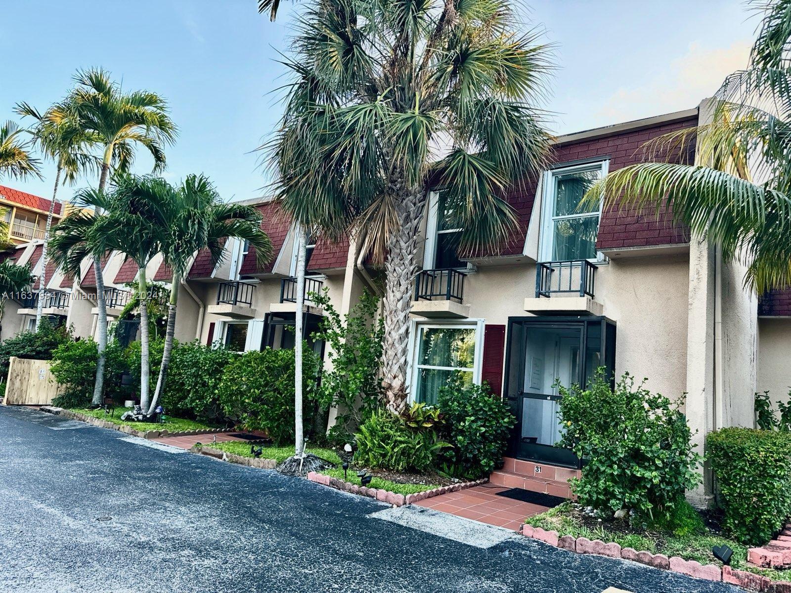 a view of a palm trees front of house