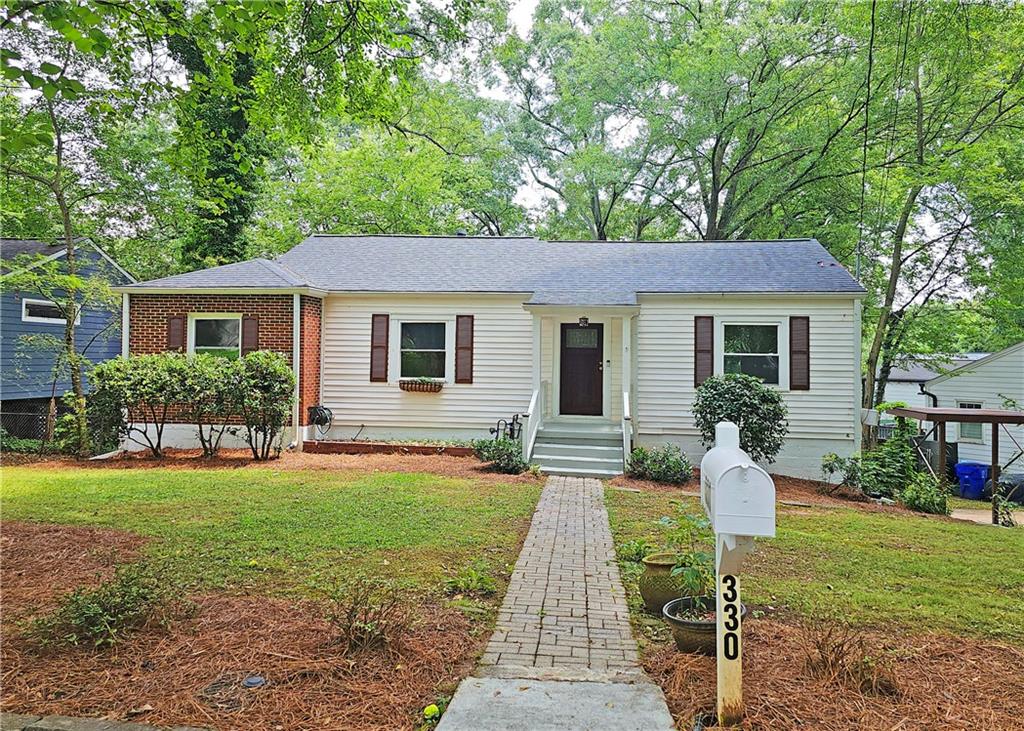 a front view of house with a garden and patio