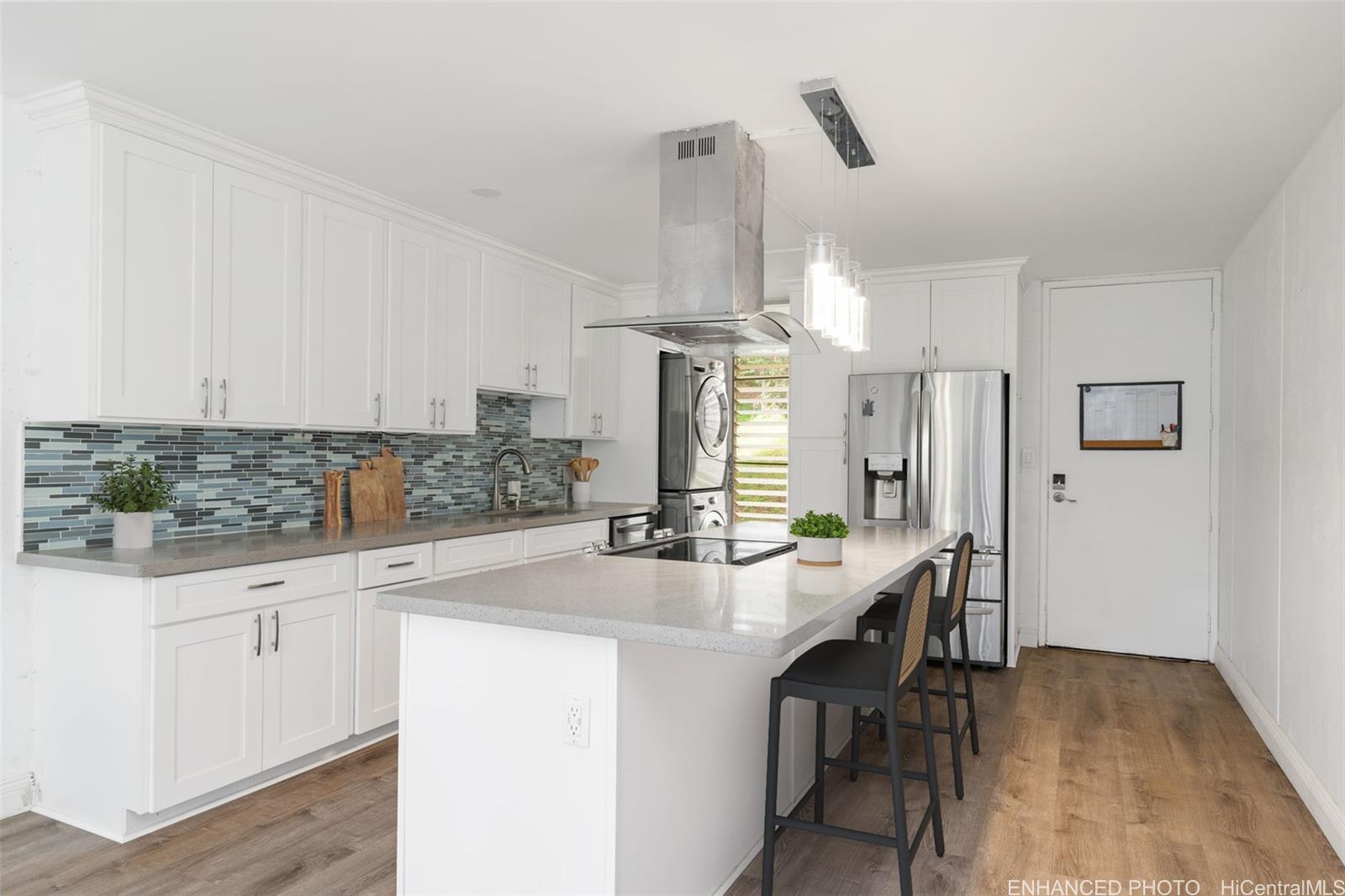 a kitchen with kitchen island a sink appliances and cabinets