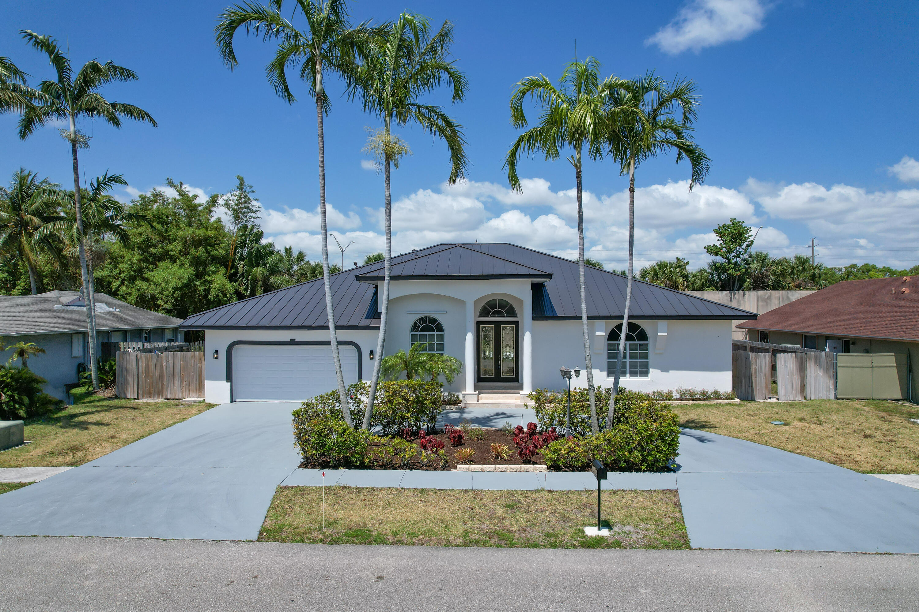 a front view of a house with a garden