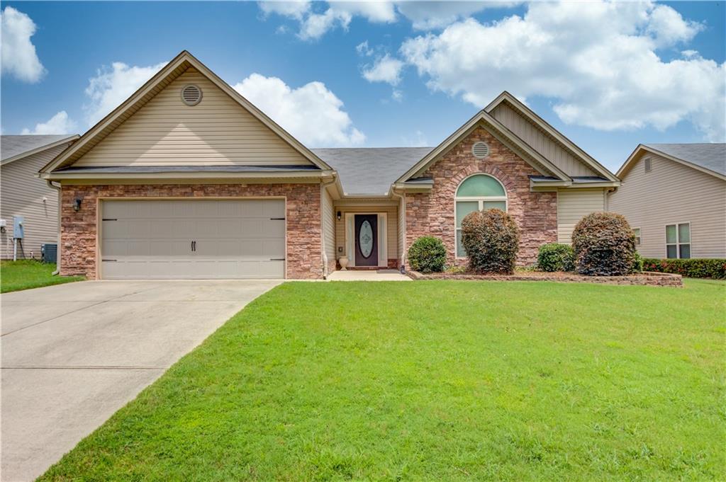 a front view of a house with a yard and garage