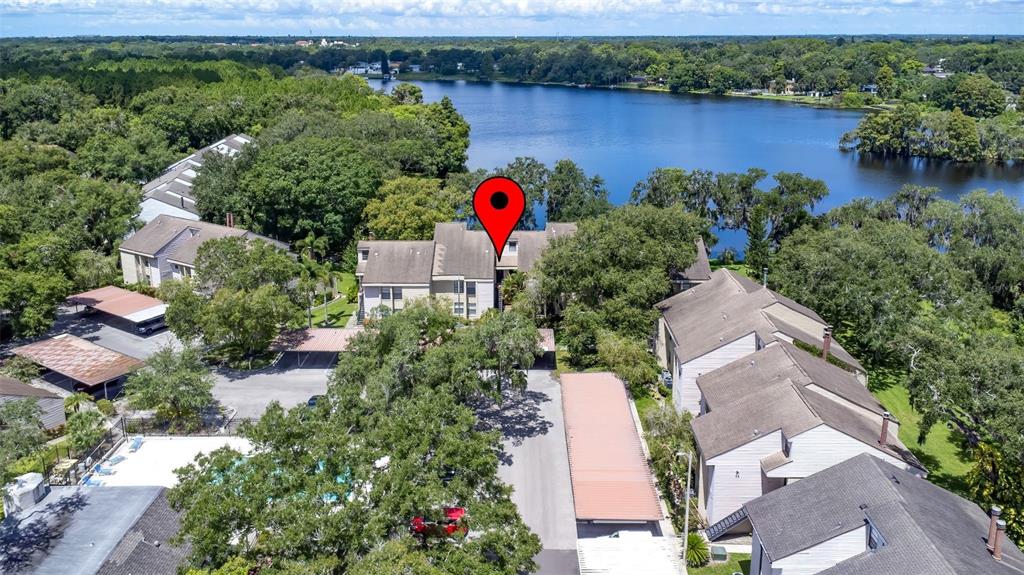 an aerial view of a house with outdoor space and lake view