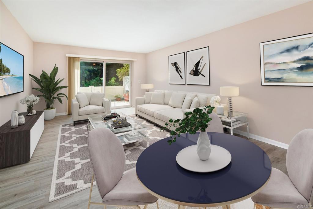 a living room with furniture a window and a wooden floor