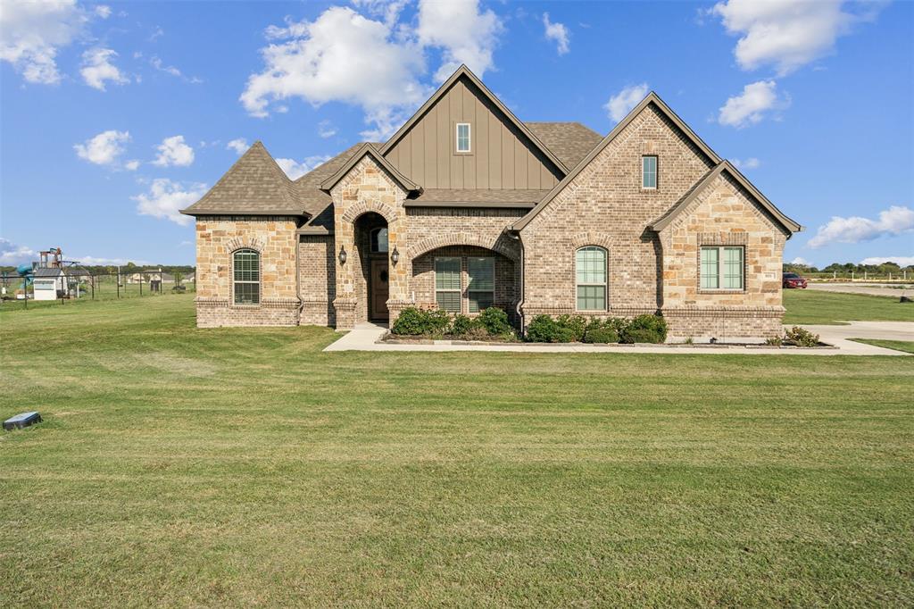 a front view of a house with a big yard