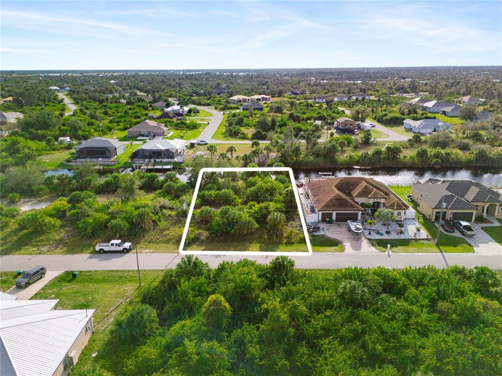 an aerial view of a house with a garden and lake view